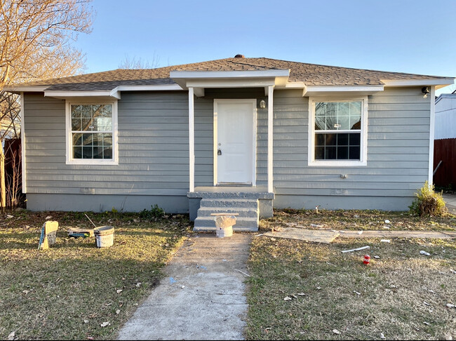 Single-story gray siding home in Dallas recently refreshed by Living Way Properties